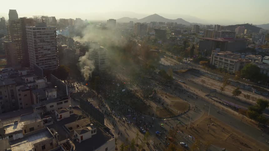 Large protest with smoke and fire overruns streets in Chile