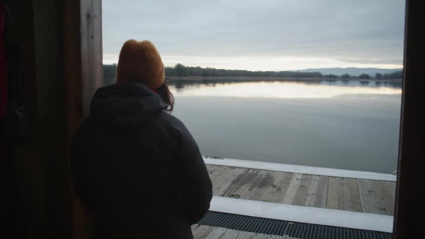 A woman is looking out over the lake