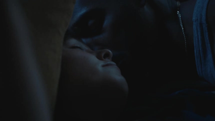 Close up of the faces of a young couple cuddling in bed at night