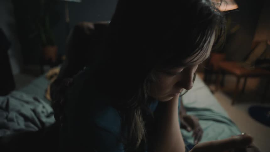 A man tries to comfort his partner while she cries with a lighter