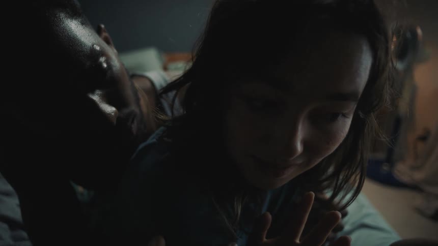 Woman speaks angrily to man trying to comfort her before she starts playing with a lighter