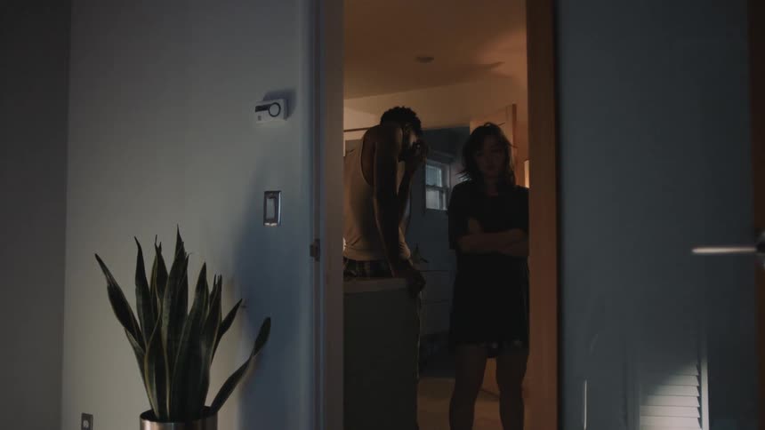 Young couple standing next to each other on a room at home