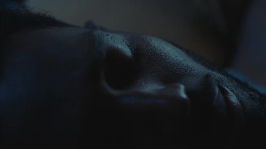Man lying in bed asleep turns his head