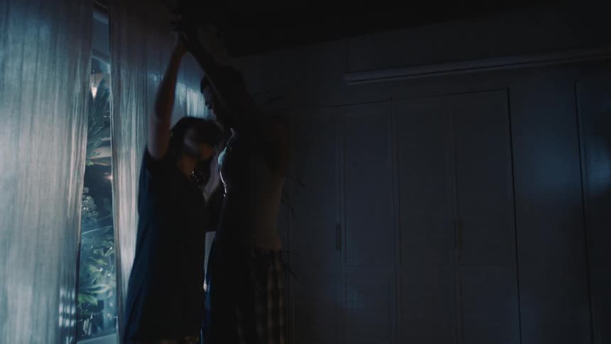 A couple dance in the bedroom