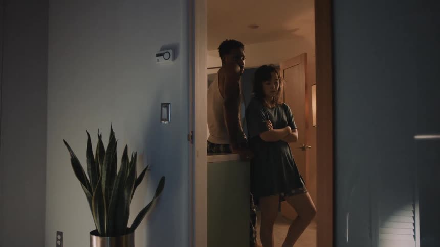 Young couple stand silently next to each other on a room at home