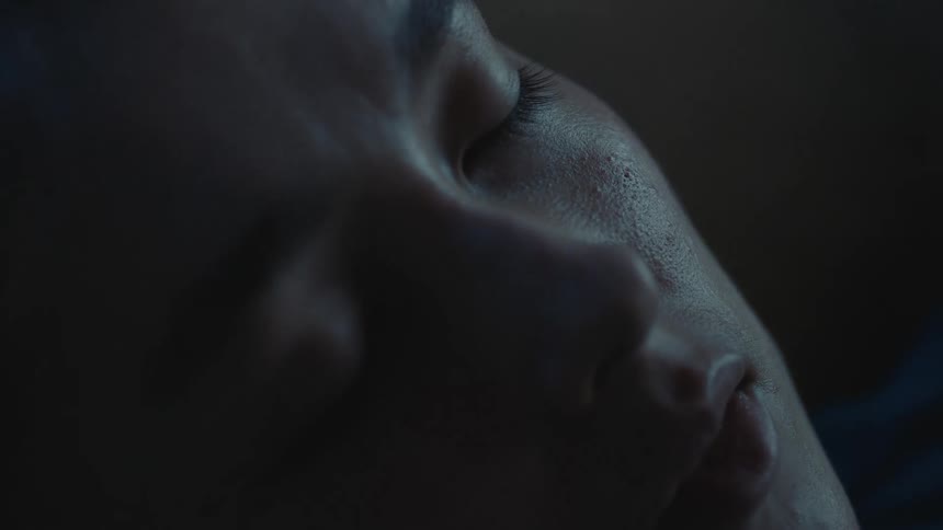 Close up view of a person sleeping is displayed