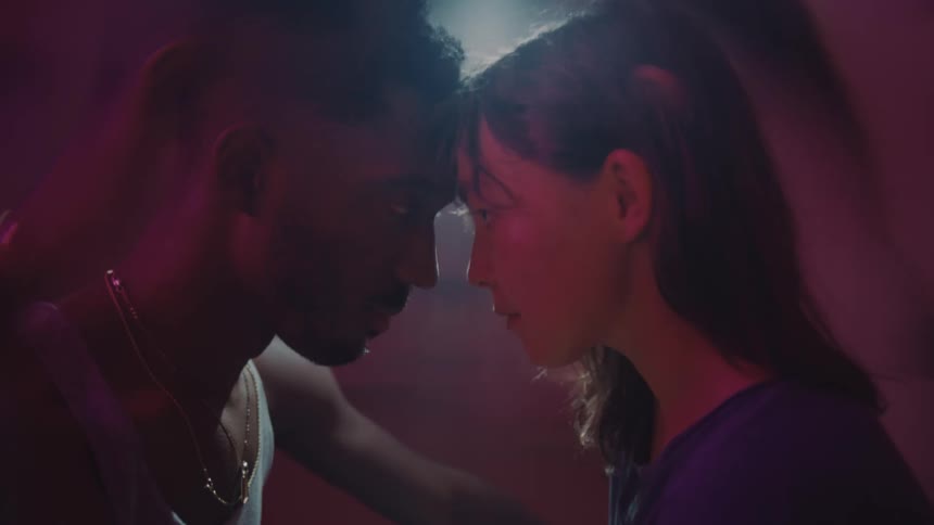 Young couple touching foreheads look at each other in the eyes while the room spins around them