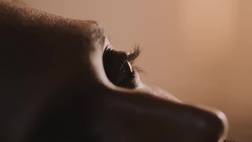 A person blinks their eyes as they wake