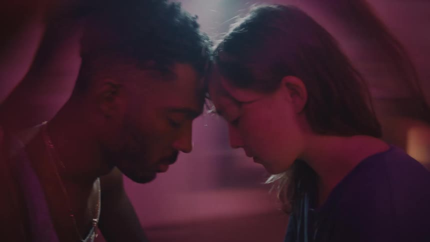 Young couple touching foreheads while the room spins around them