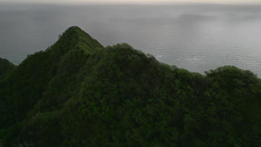 Aerial view of an island at dusk is displayed