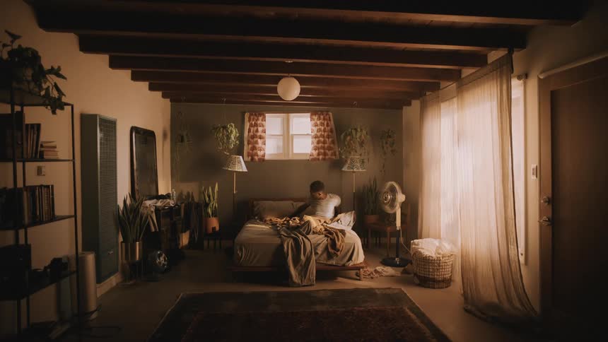Sleeping man slowly wakes up on a cozy comfortable bedroom