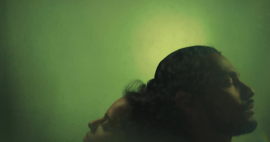 The heads of a sad looking couple leaning on each other