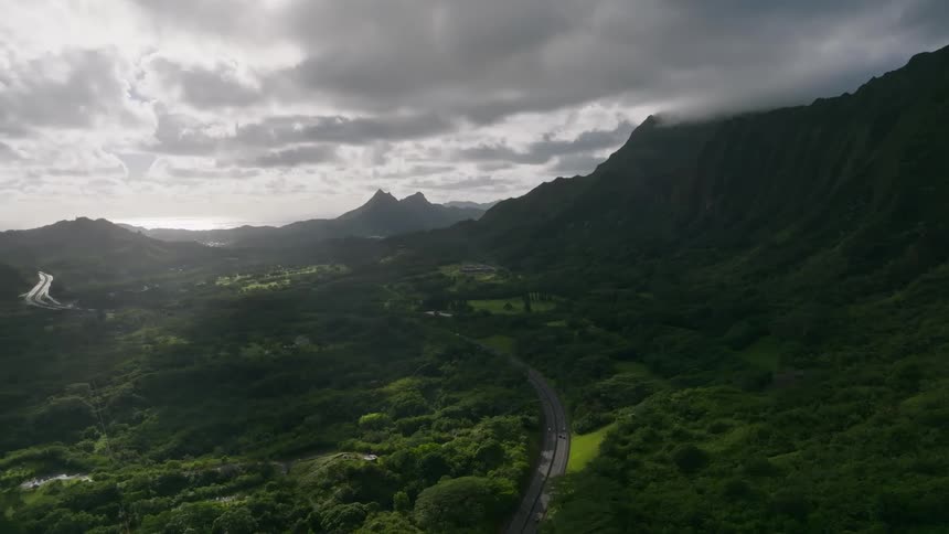 Cars travel on the road by the mountains
