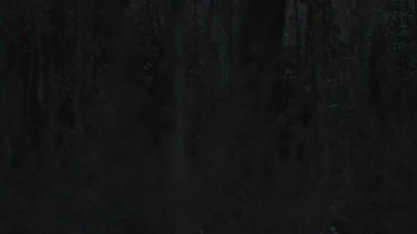 A man is hiking through the forest