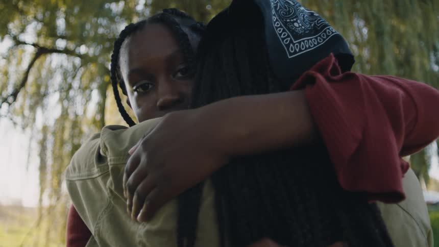 Two people hugging each other outdoors