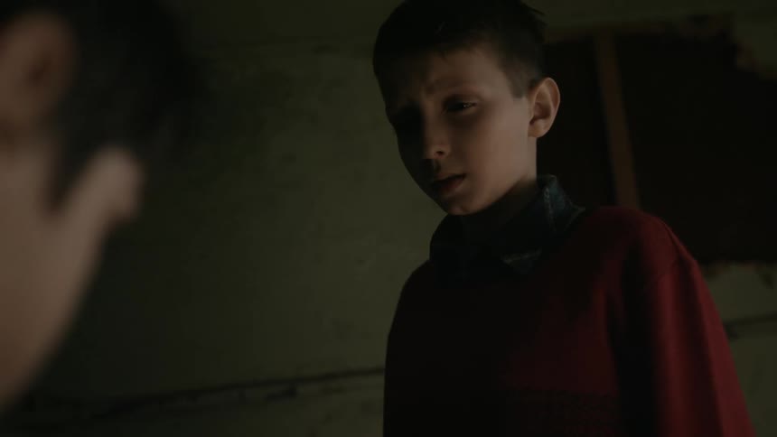 Two children talk and one walks away