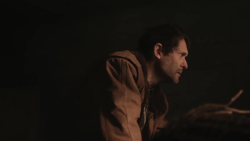 Weak powerless man stands up inside a dirty room on an abandoned building