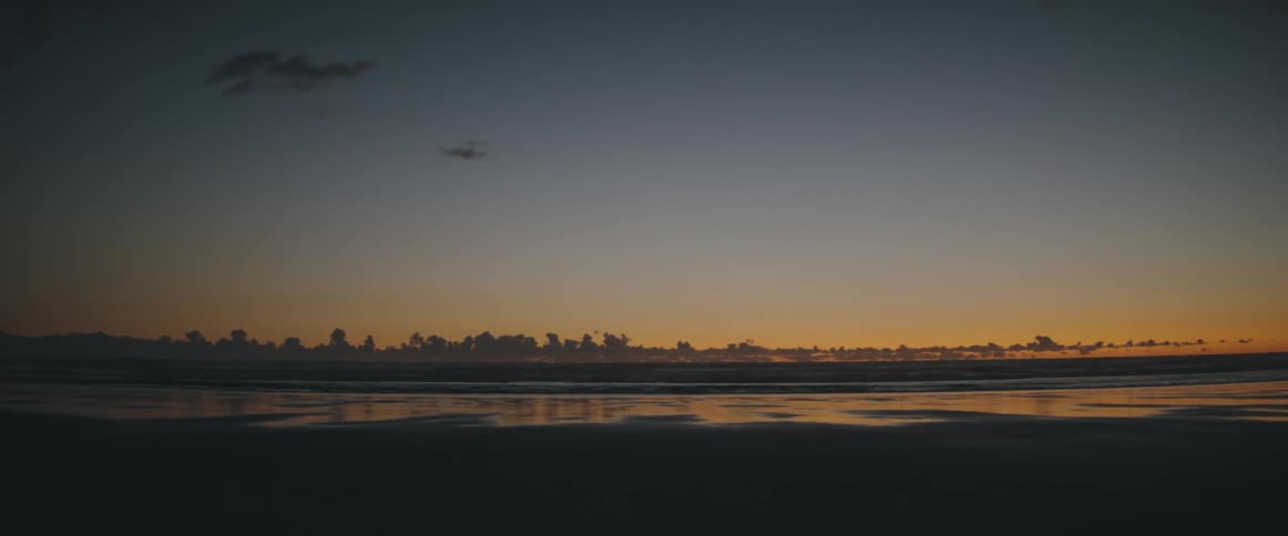 A beach at sunset with the horizon
