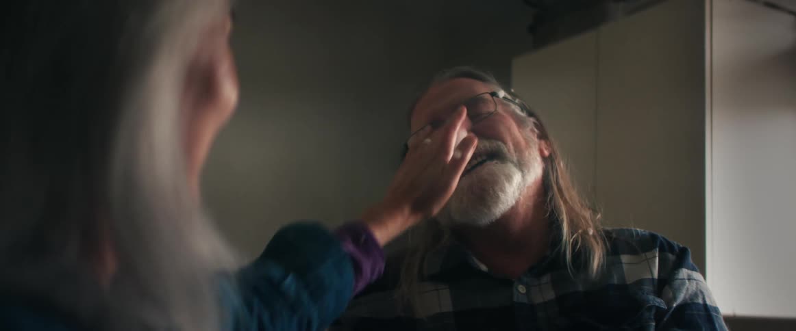 A man and woman are laughing together