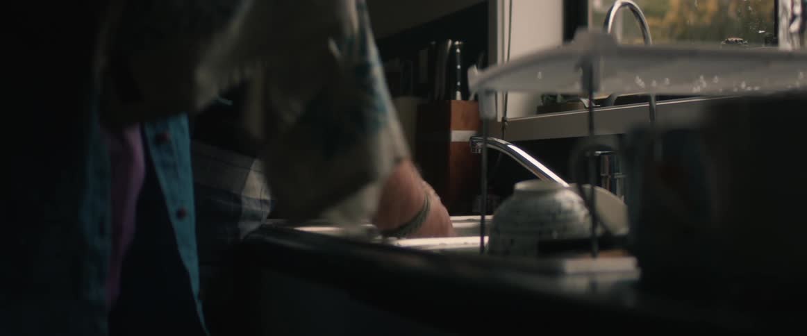 Two people are washing dishes together
