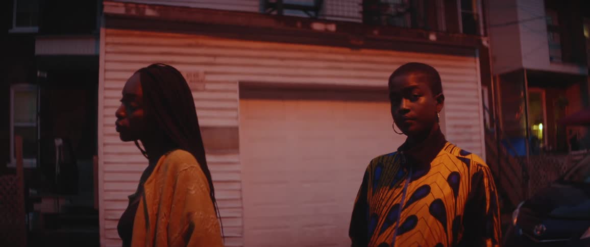 Two women standing outdoors at night