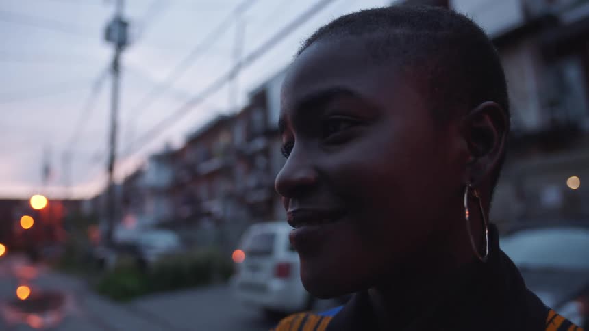 A woman is smiling by the homes