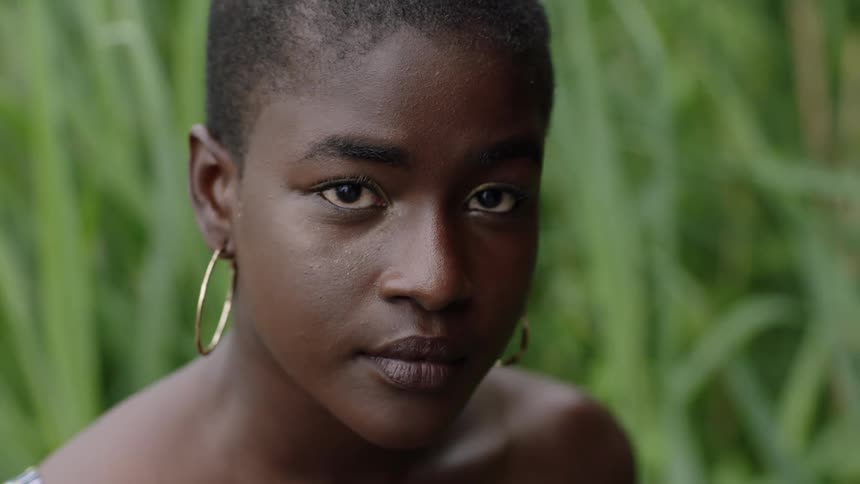 A teenage girl outside poses for a portrait