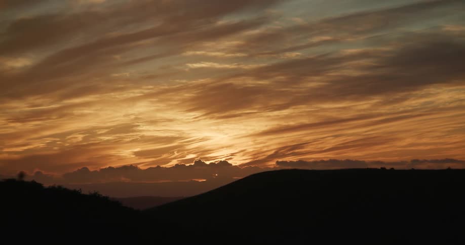 Landscape of sun going down behind the clouds