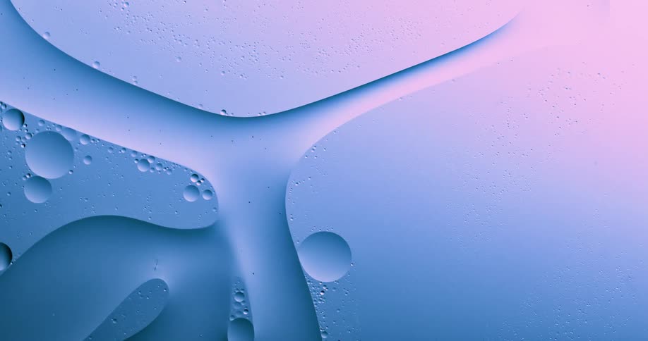 Orbs are floating in a liquid substance as they move along a path around a larger object