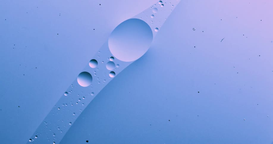 A large sphere and orbs of different sizes move in a liquid path