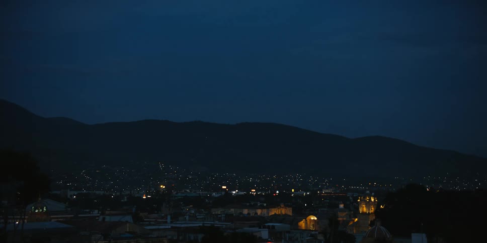 A skyline with houses lit up at night