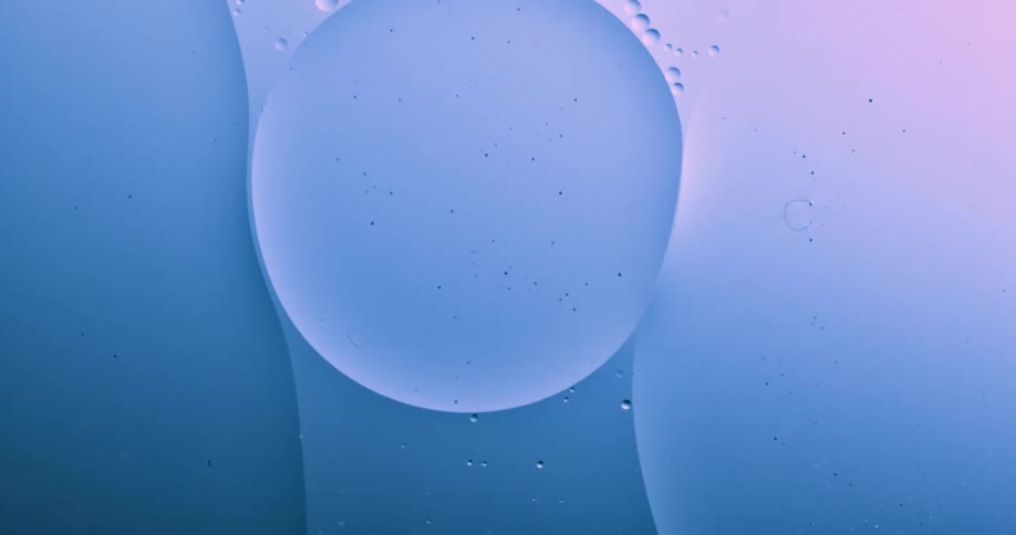 A large orb moves on a path as smaller spheres surround it as it moves