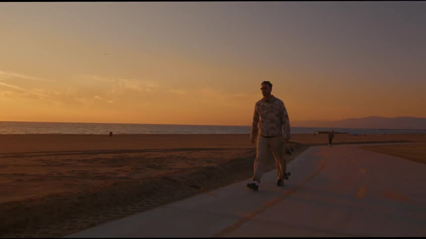 A man is walking on the boardwalk