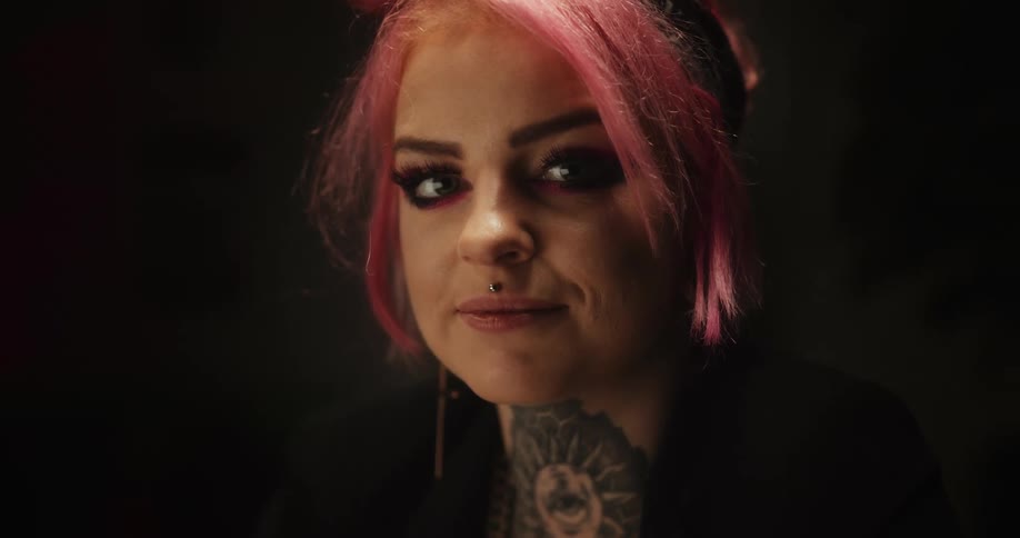 Close up of the face of a tattoo artist looking at the camera