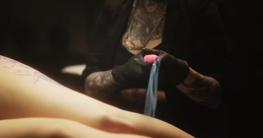 A tattoo artist prepares to service a client