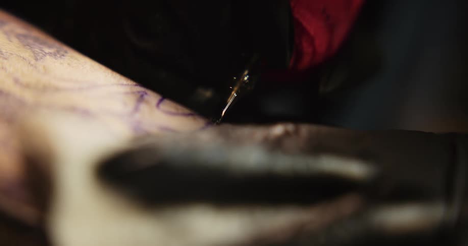 A person is tattooing an image onto another persons skin