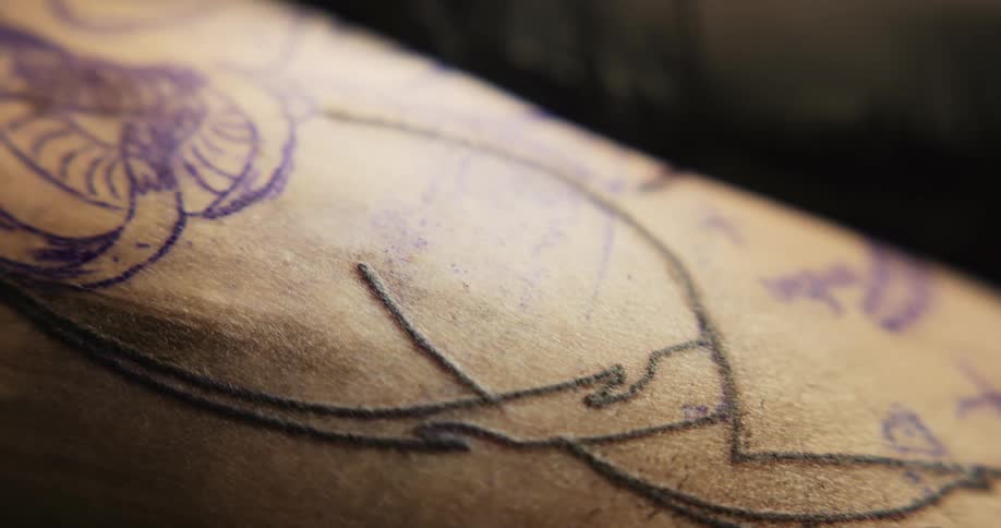 Close up of a fresh tattoo being drawn on the skin of a person
