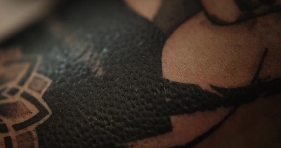 Close up view of a fresh tattoo with a lot of black ink