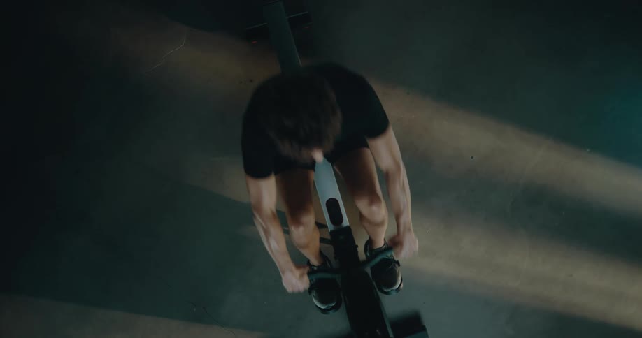 A man is exercising on a rowning machine