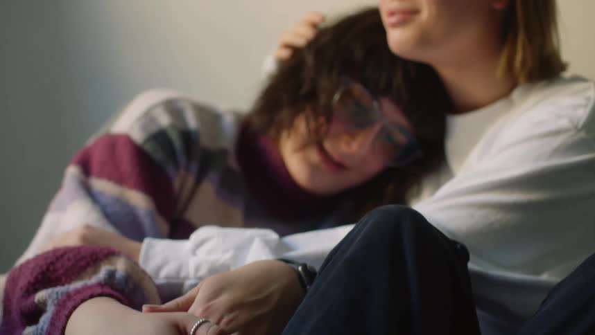 A young couple is hugging each other in the middle of the day time
