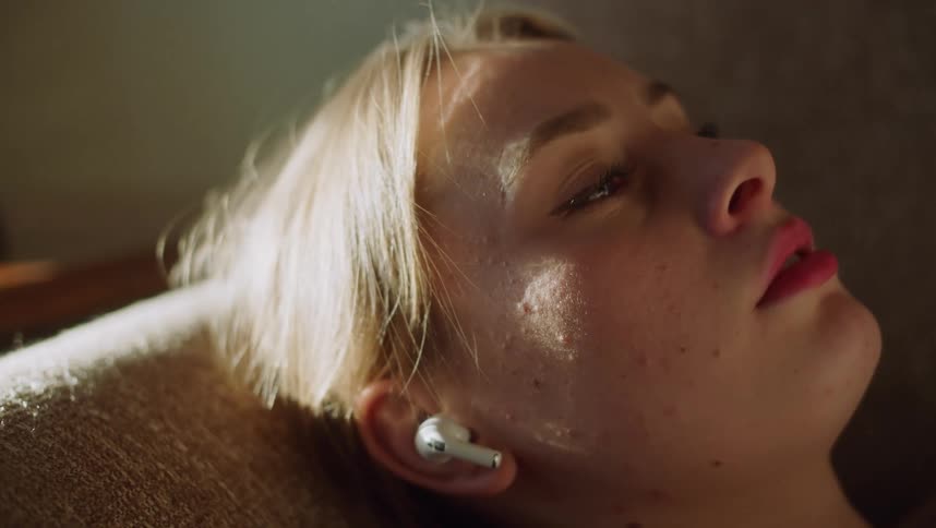 Sunlight shines on a woman sleeping in a chair
