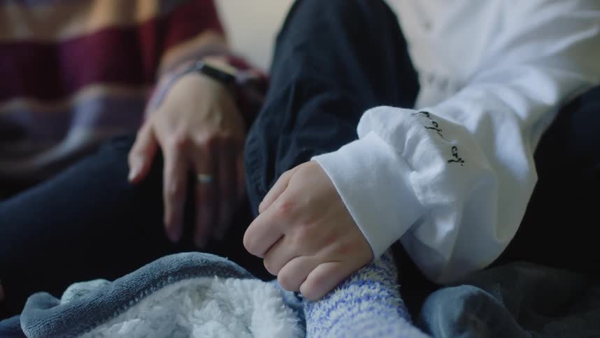 Two people sits on blanket together