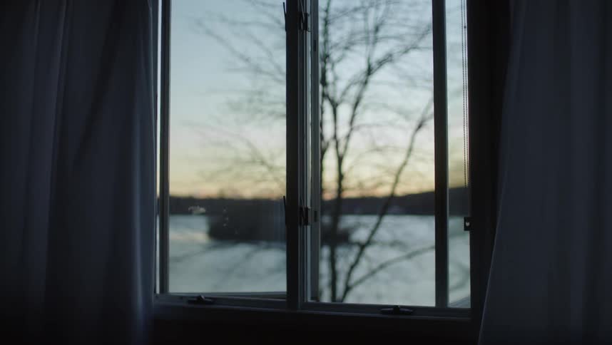 Calm winter landscape seen through a window at evening