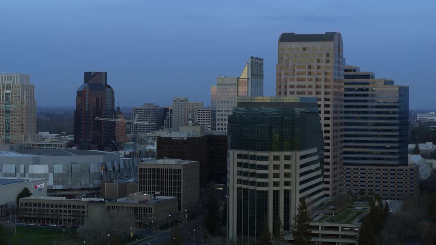 Aerial moving down river revealing California capitol building in Sacramento