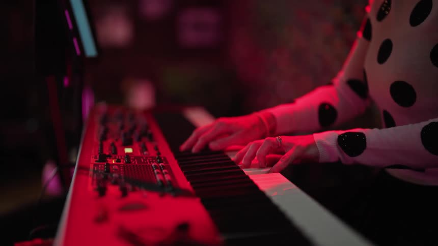 There is a woman that is playing the keyboard inside