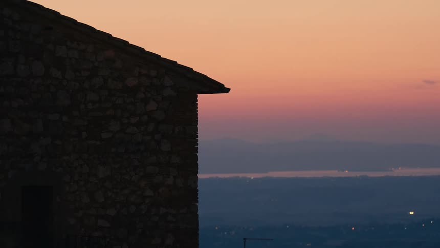 A brick building sits at a vantage point over a neighborhood