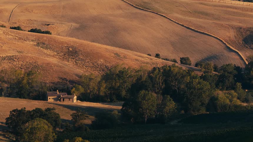The sun is setting in a rural area during spring