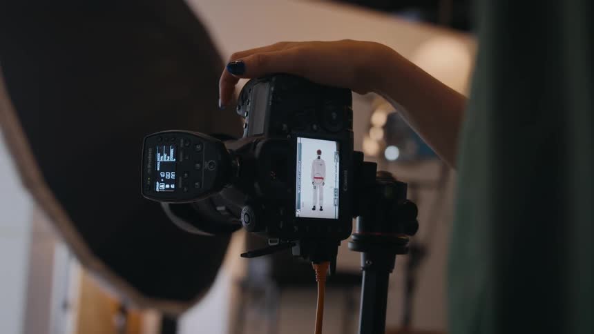 A photographer shoots photos of a male model in the studio