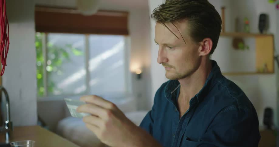 A man types information from a white card