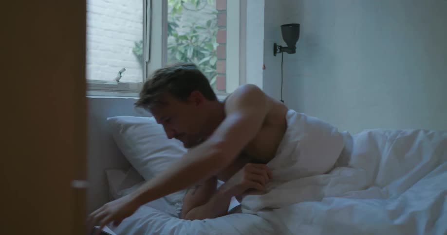 A man wakes up and checks his phone